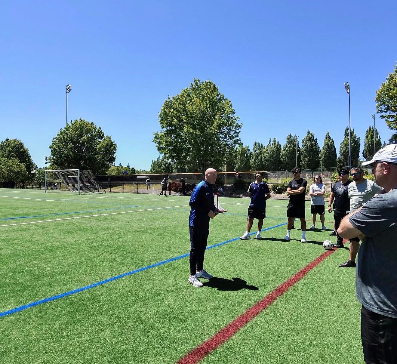 Coaches on a turf field during a US Soccer coaching course